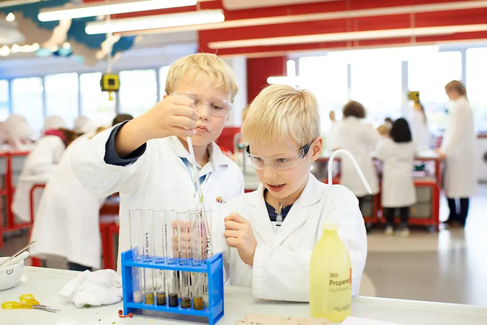 two blond boys at lab bench