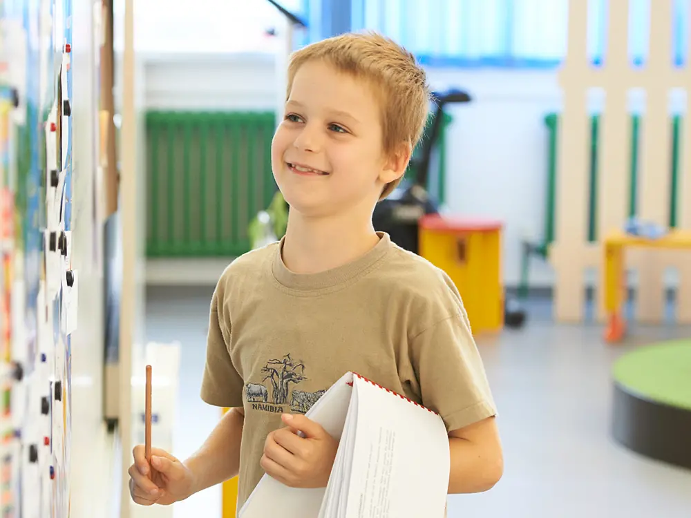 blond boy stands at whiteboard