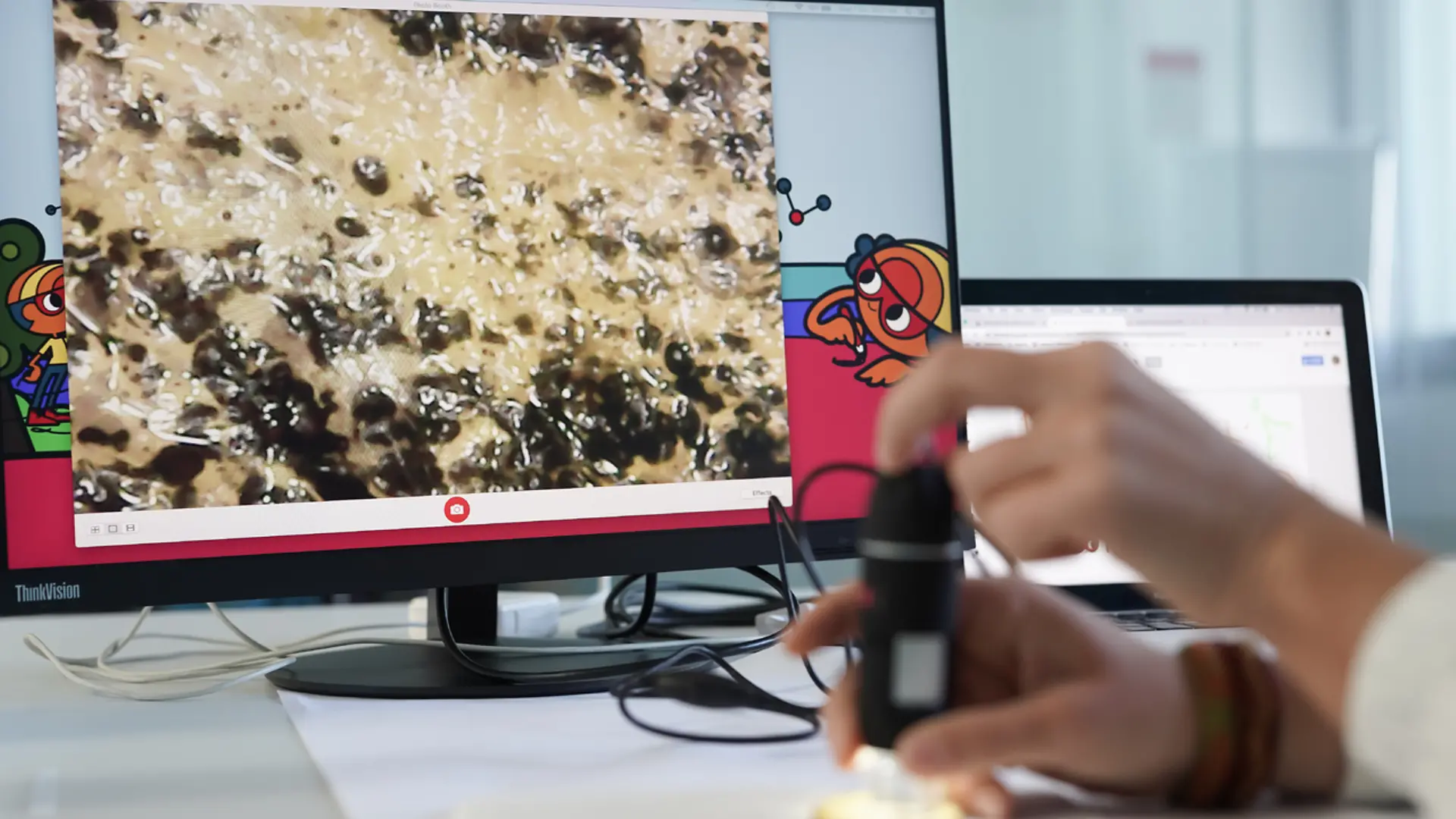 computer screen with close up of hand in front