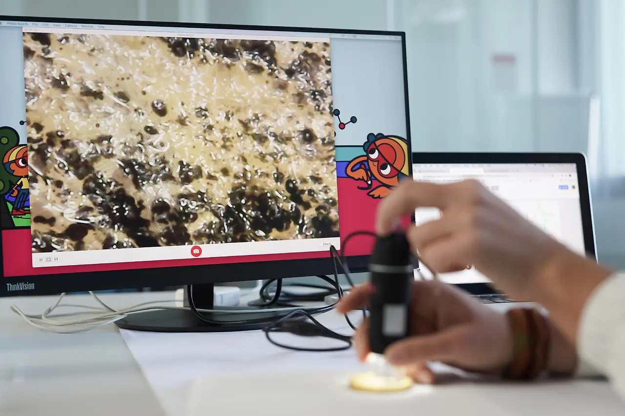 computer screen with close up of hand in front