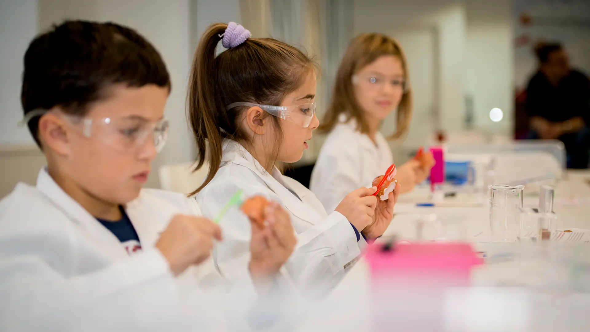 three kids in lab coats