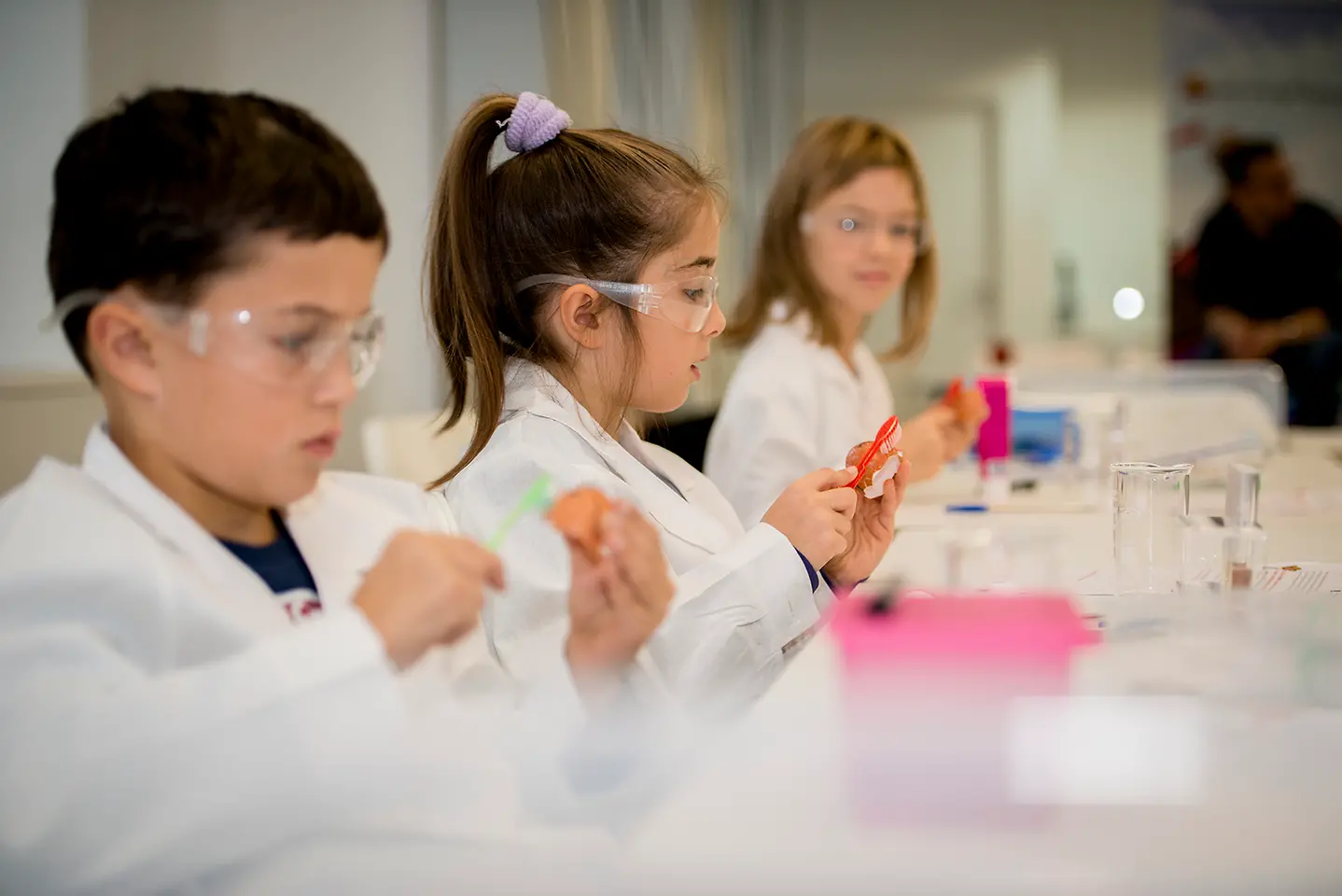 three kids in lab coats