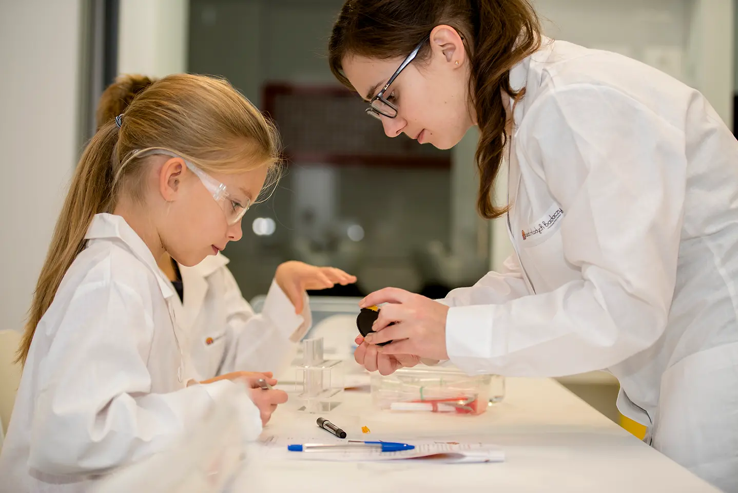 kid and female in lab coats