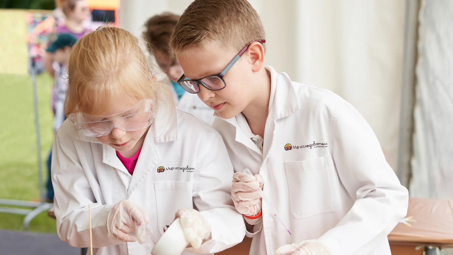 boy and girl in lab coats