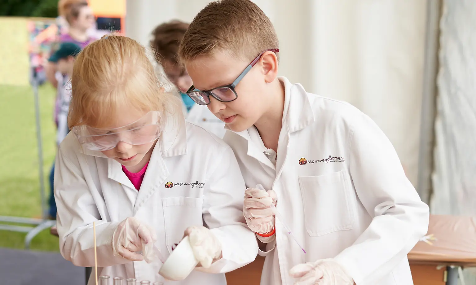 boy and girl in lab coats