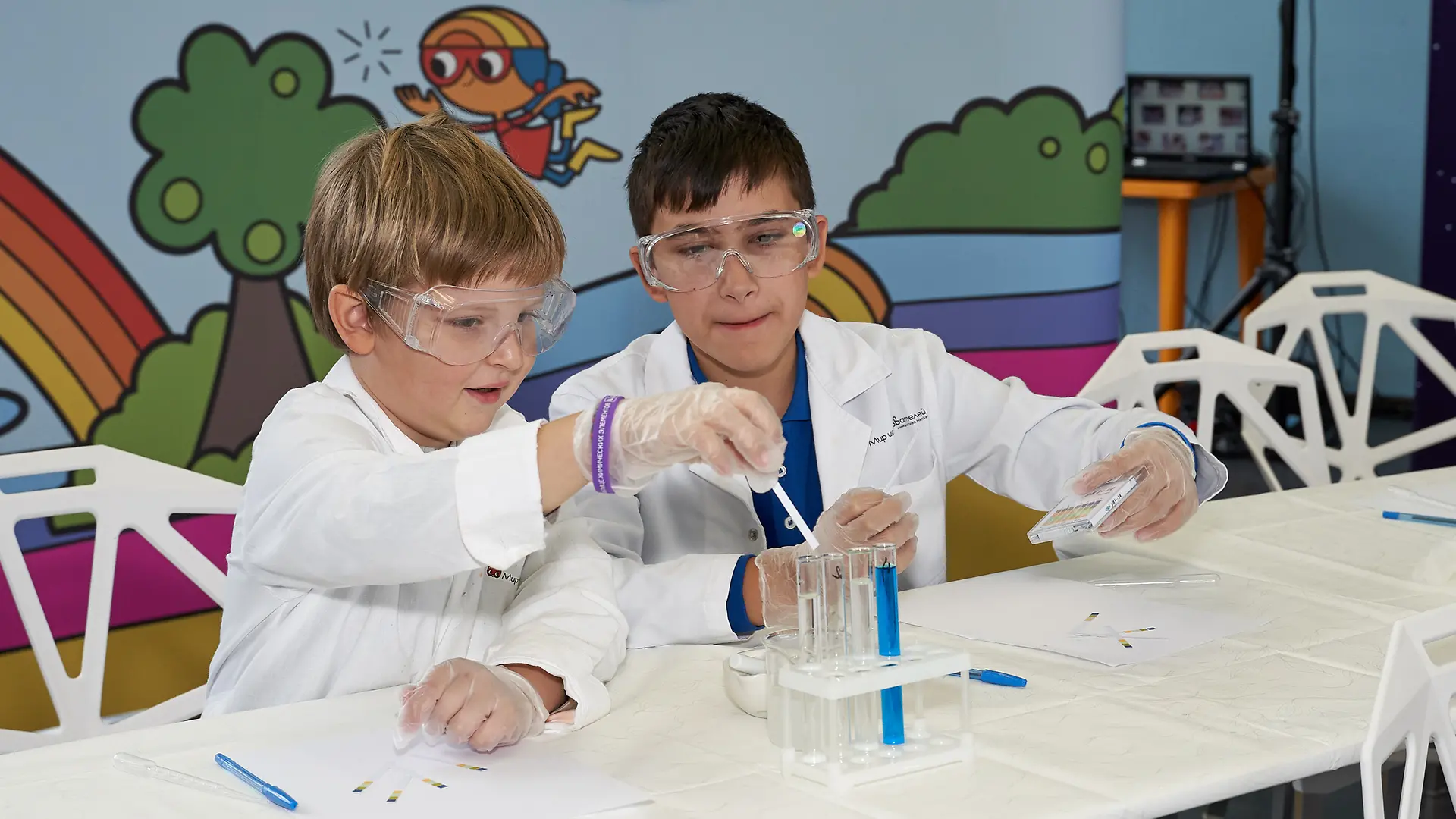 two boys sitting at white table