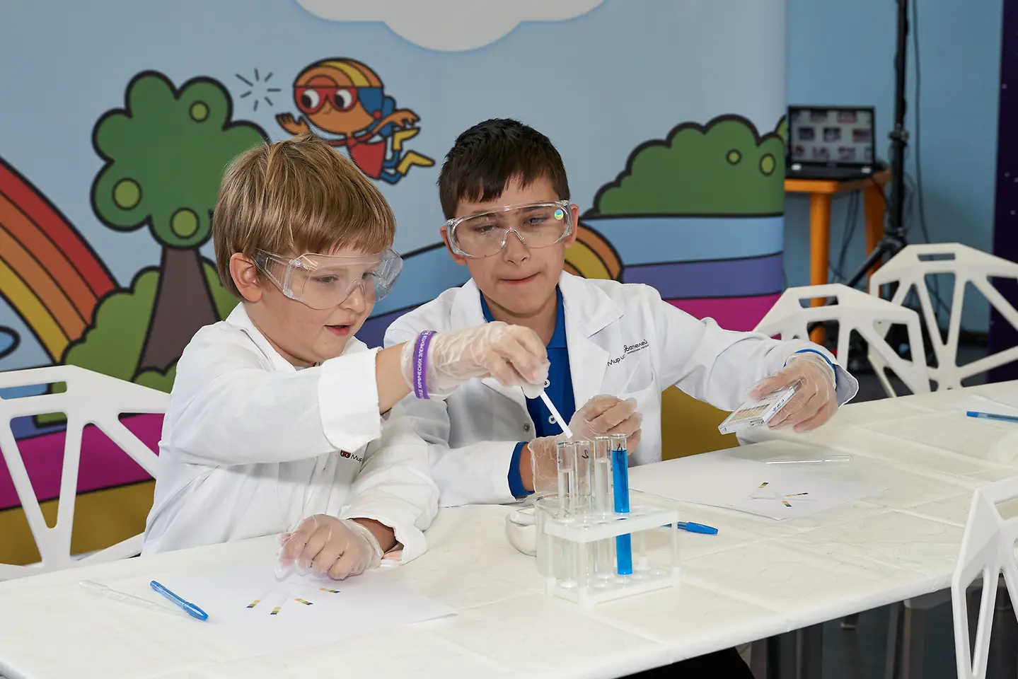 two boys sitting at white table