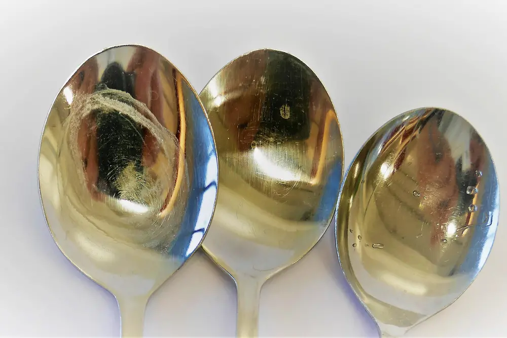 three spoons with white residue