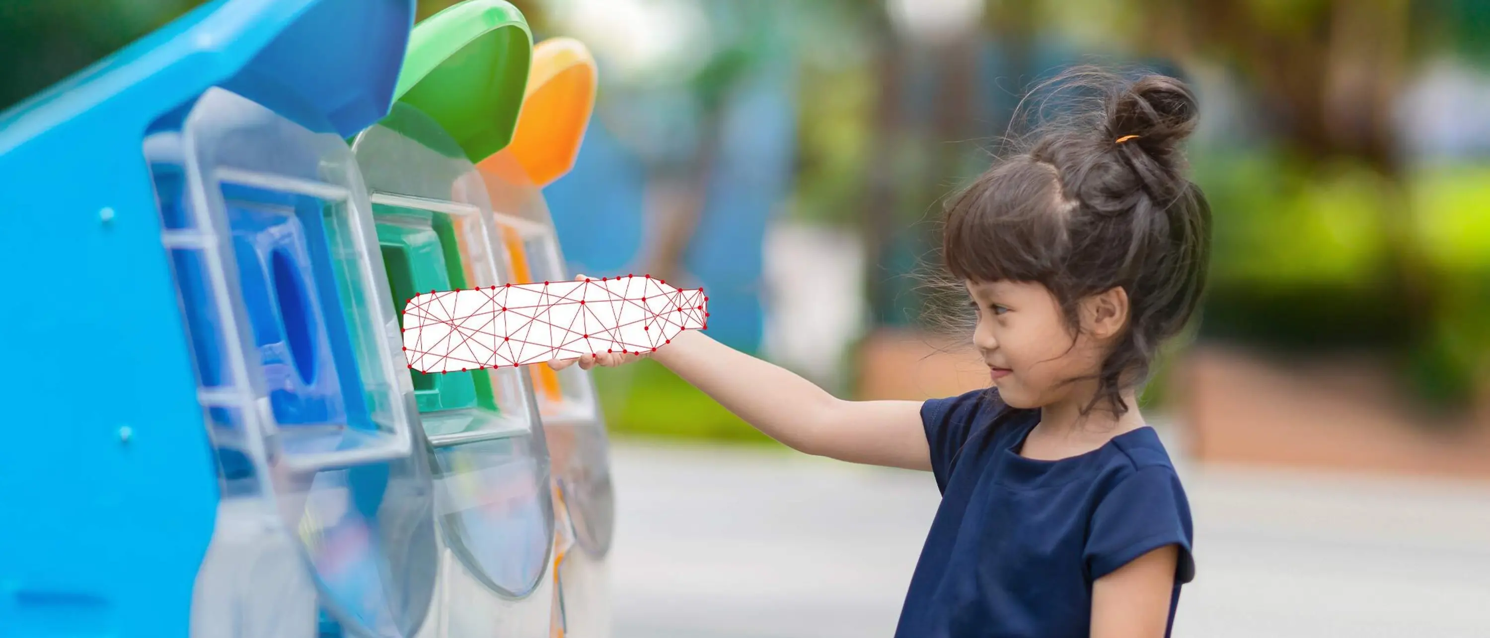 girl puts bottle in recycling container