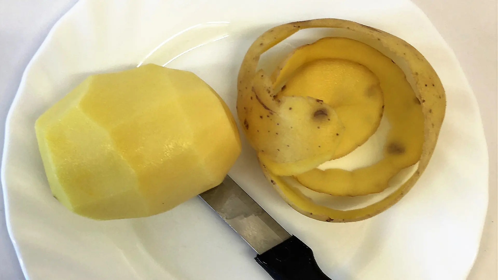 pealed potato on white plate