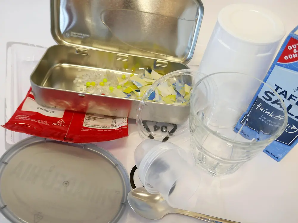 assortment of plastic materials, salt and glass jar