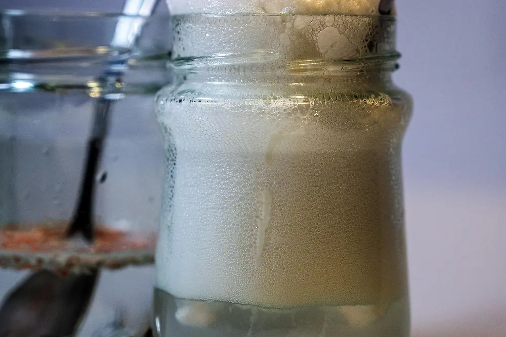 close up of glass jar with foaming liquid