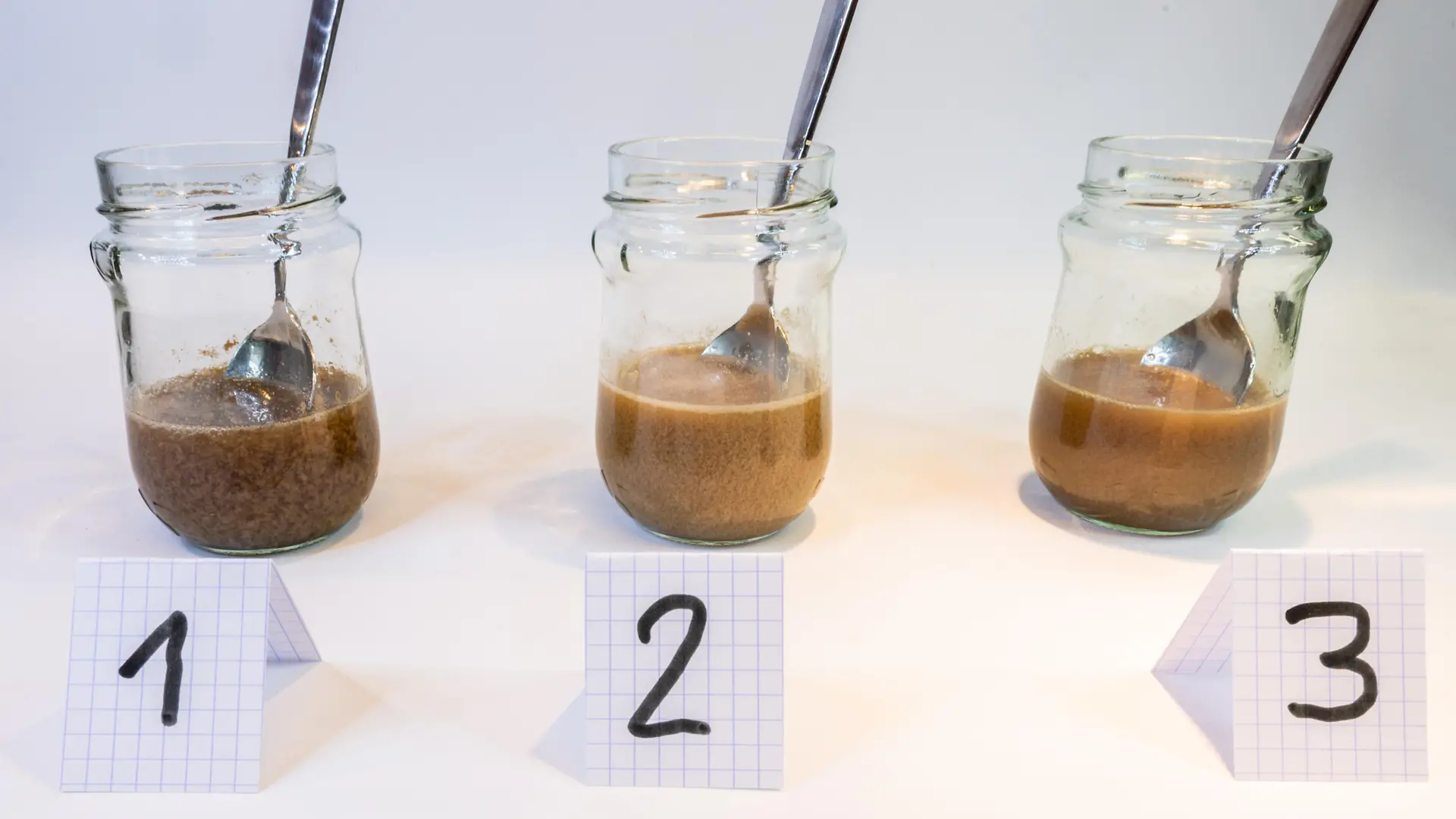 three glass jars with medium brown milky liquids