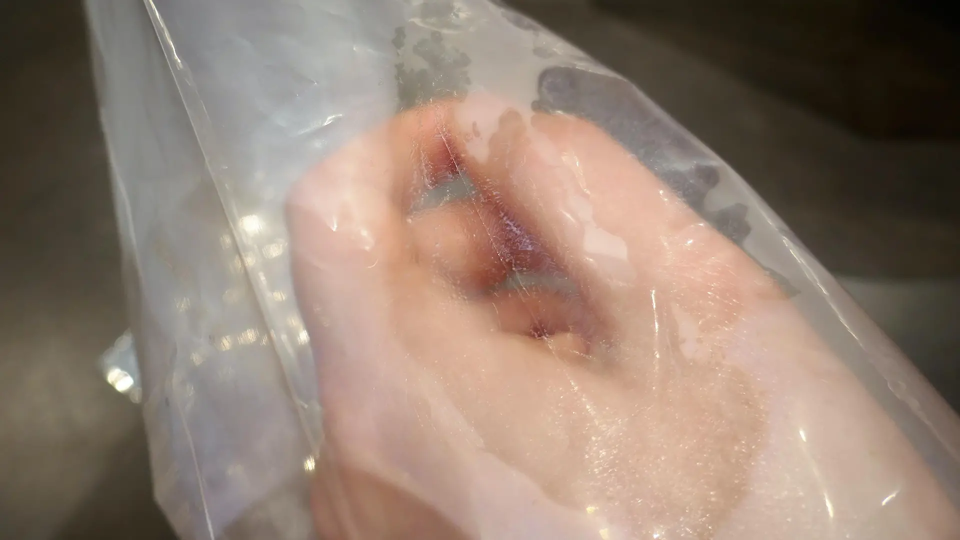 close up of one hand in freezer bag