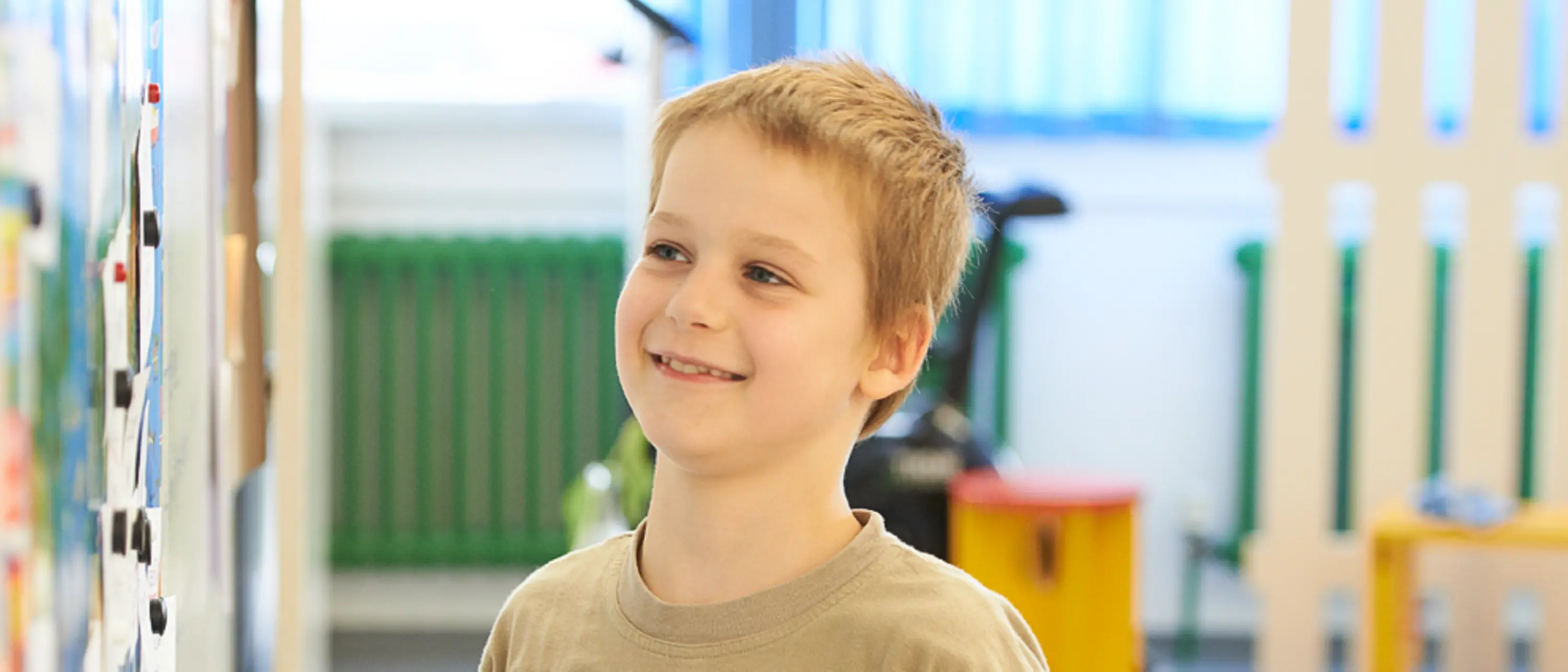 blond boy stands at whiteboard