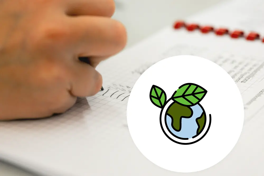 hand writing on a paper with graphic of of the world surrounded by a line with with 2 green leaves on top